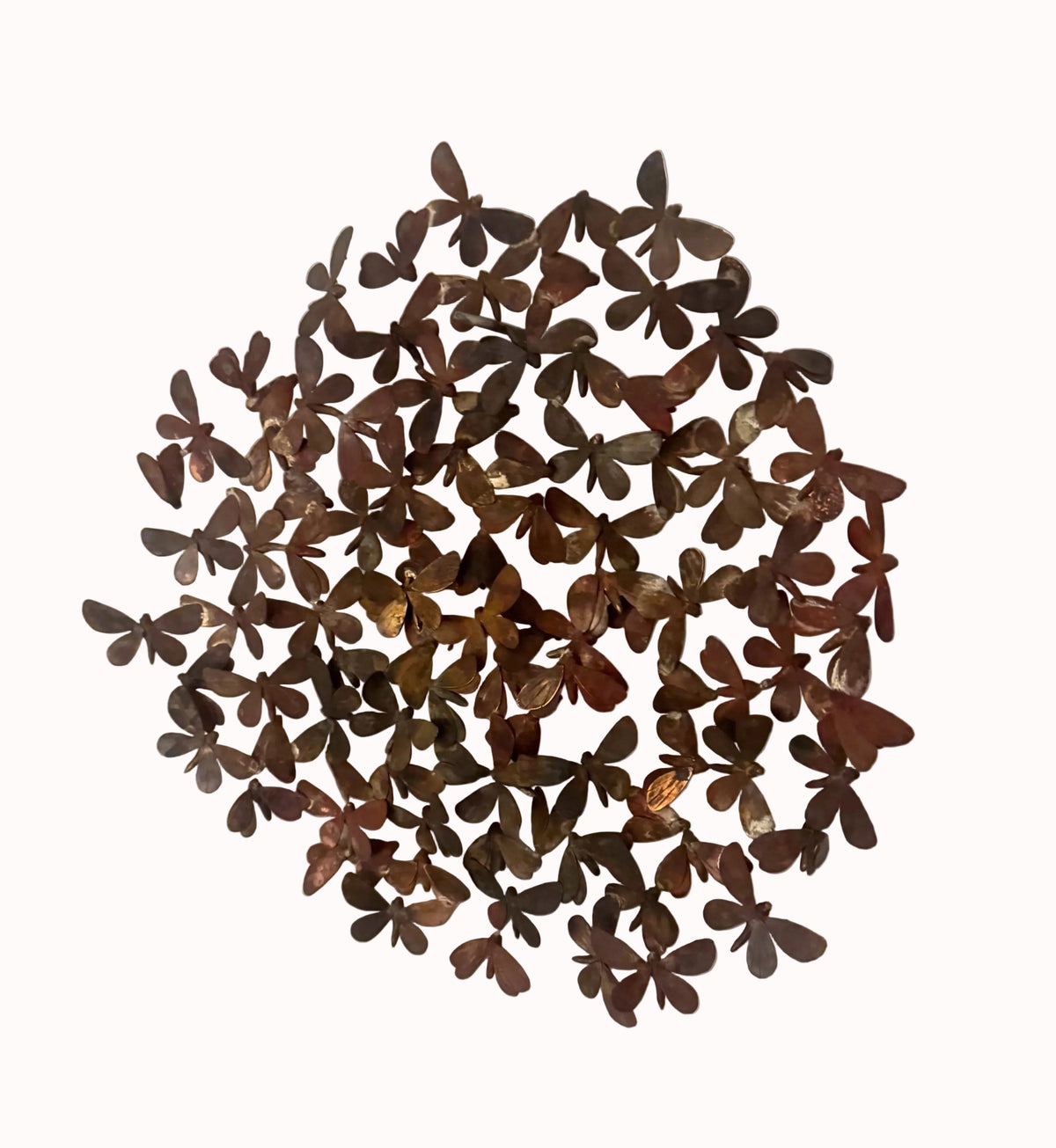 A circular wall art piece made of many small butterfly-shaped metal pieces in dark brown and bronze tones